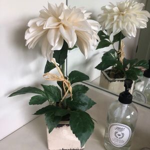 Faux white flower arrangement with river rocks